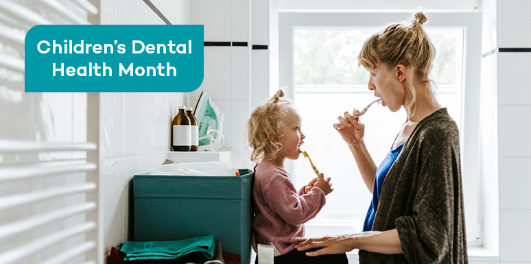 Caucasian mother and daughter brushing teeth together